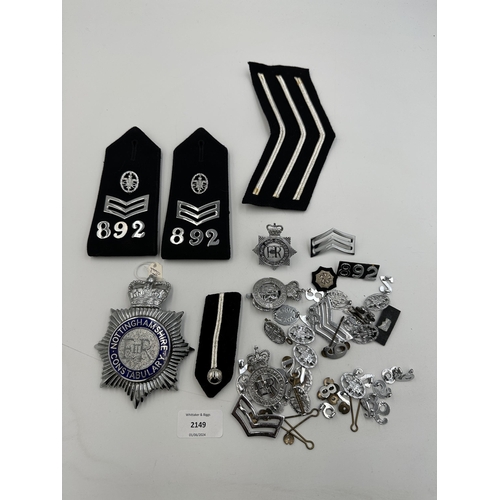 2149 - A collection of police uniform accessories to include Nottinghamshire Constabulary helmet plate, cap... 