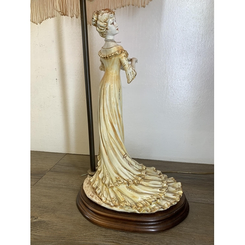 577 - A Capodimonte ceramic figural table lamp with hand painted floral shade - approx. 72cm high