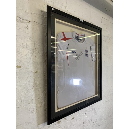 620 - Two items of signed football memrobilia, one framed England shirt signed 'M Owen' and one football s... 