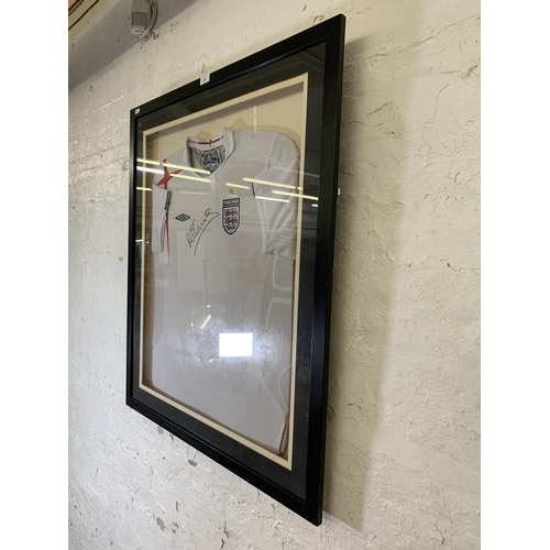 620 - Two items of signed football memrobilia, one framed England shirt signed 'M Owen' and one football s... 