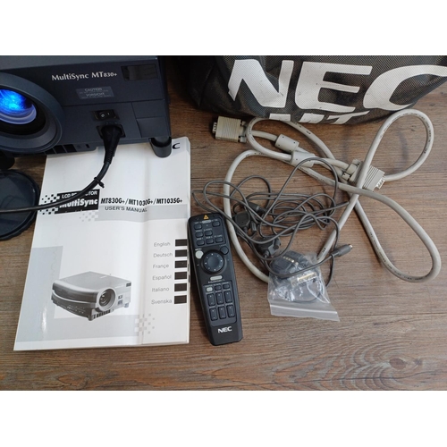 678 - A cased NEC MT830G+ MultiSync LCD projector with cables, remote control and instruction manual