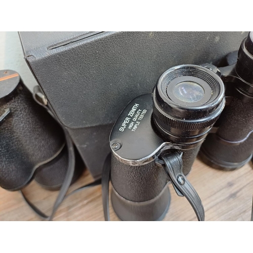 682 - A collection of binoculars to include cased Super Zenith 10x50 wide angle, cased Falcon 6x-18x zoom,... 