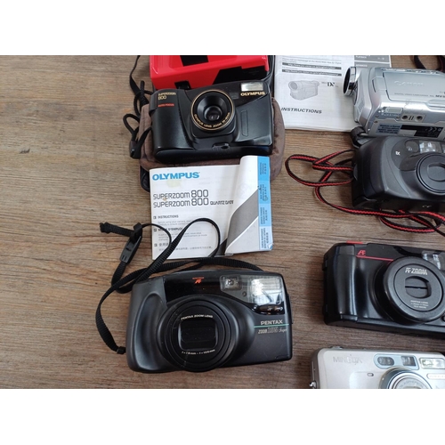 684 - A collection of camcorders and cameras to include two Olympus Trip MD2, Olympus Superzoom 800 with i... 