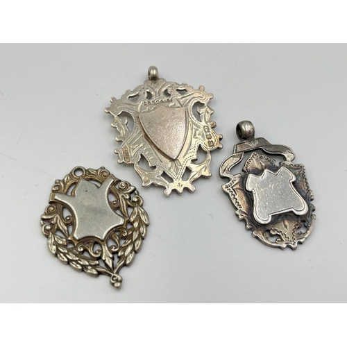 2067 - Three watch fobs/medallions, two hallmarked Birmingham silver and one white metal - approx. gross we... 