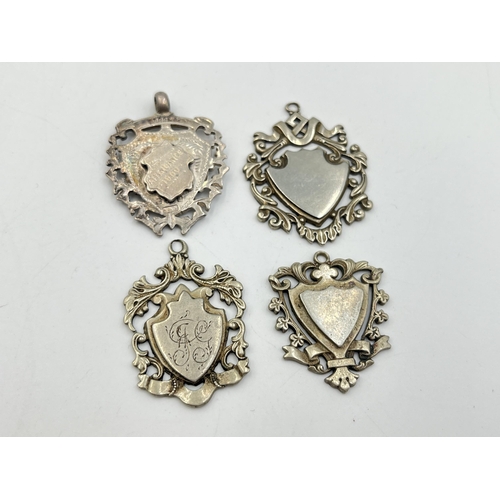 2072 - Four watch fobs/medallions, three white metal and one hallmarked Birmingham silver - approx. gross s... 