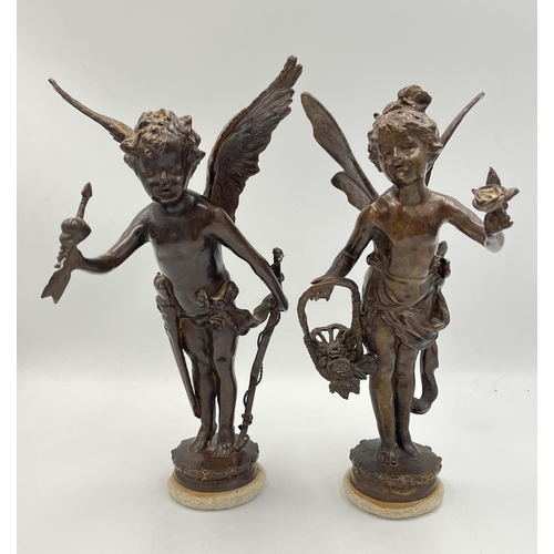 2083 - Two bronzed cast metal cupid figurines - approx. 24cm high