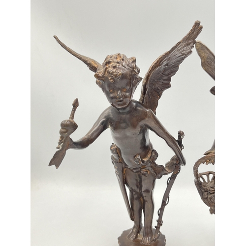 2083 - Two bronzed cast metal cupid figurines - approx. 24cm high