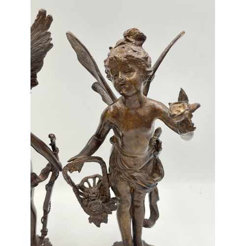 2083 - Two bronzed cast metal cupid figurines - approx. 24cm high