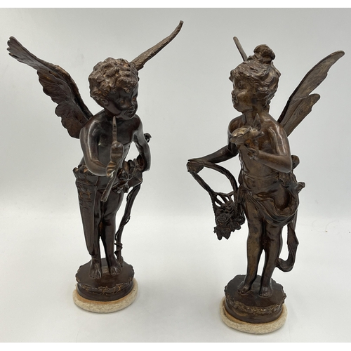 2083 - Two bronzed cast metal cupid figurines - approx. 24cm high