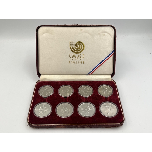 2088 - A cased set of eight 1988 Seoul Olympics South Korean commemorative non-circulating coins, four 1000... 