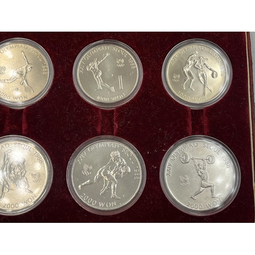 2088 - A cased set of eight 1988 Seoul Olympics South Korean commemorative non-circulating coins, four 1000... 