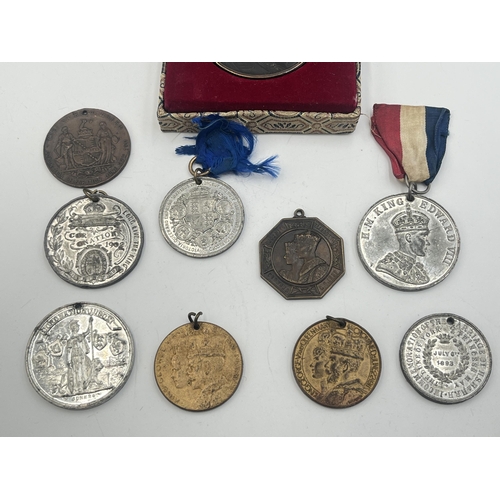 2093 - A collection of medallions to include cased Great Wall Of China, Kind Edward VIII coronation etc.