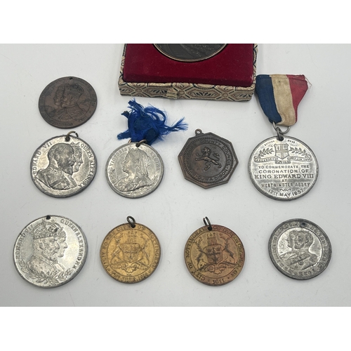 2093 - A collection of medallions to include cased Great Wall Of China, Kind Edward VIII coronation etc.