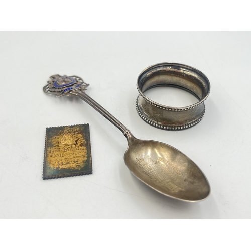 2102 - Three pieces of sterling silver, one Holyrood Palace enamel decorated commemorative spoon, one napki... 