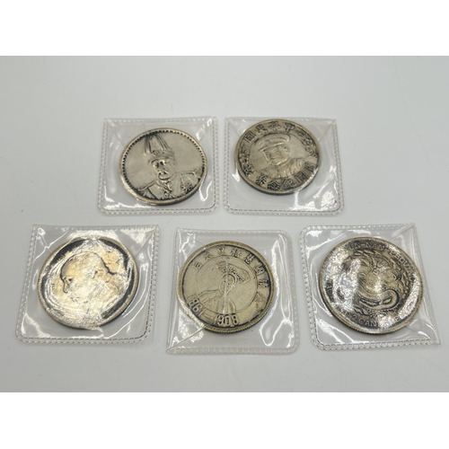 2108 - Five items, four silver plated replica Chinese coins and one token