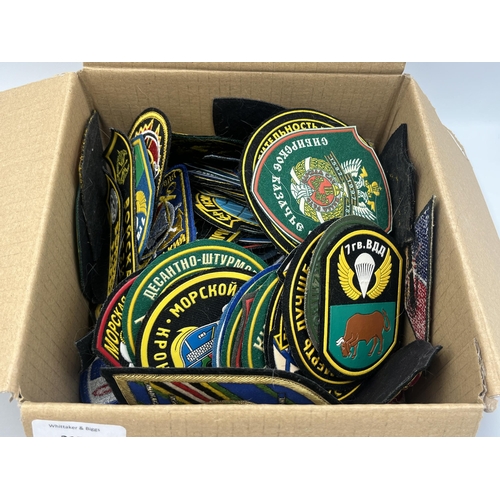 2154 - A collection of military cloth patches to include Russian etc.