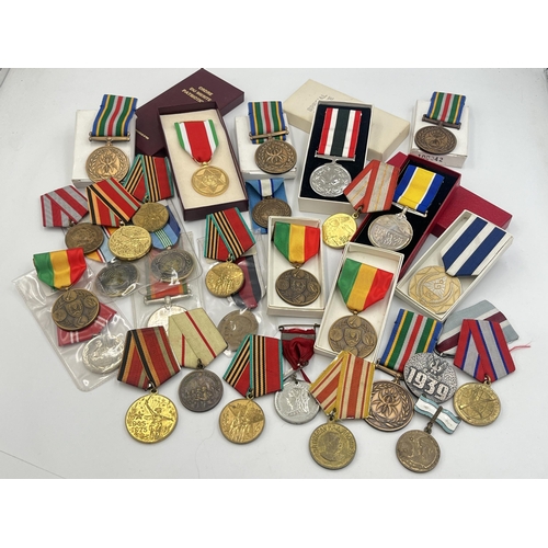 2157 - A collection of military and police medals to include Russian, Romanian Jubilee, Africa Service etc.