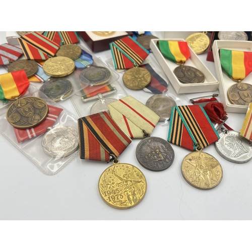 2157 - A collection of military and police medals to include Russian, Romanian Jubilee, Africa Service etc.