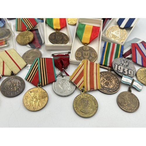 2157 - A collection of military and police medals to include Russian, Romanian Jubilee, Africa Service etc.