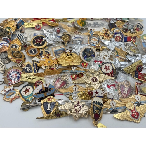 2159 - A large collection of military badges to include Russian, US Air Force wings etc.