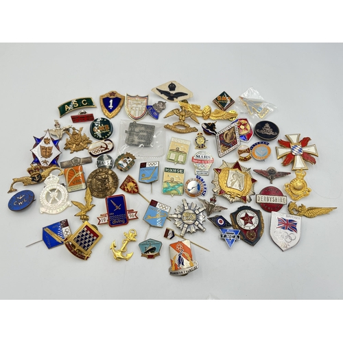 2167 - A collection of badges to include Royal Air Force mother of pearl, USSR 1972 Olympics enamel etc.