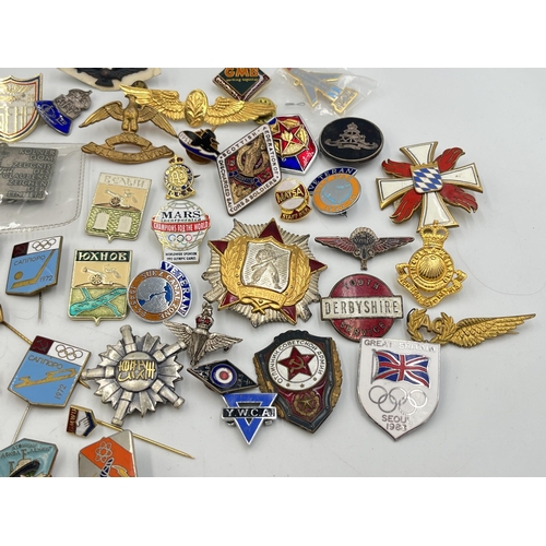 2167 - A collection of badges to include Royal Air Force mother of pearl, USSR 1972 Olympics enamel etc.