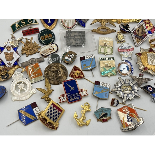 2167 - A collection of badges to include Royal Air Force mother of pearl, USSR 1972 Olympics enamel etc.