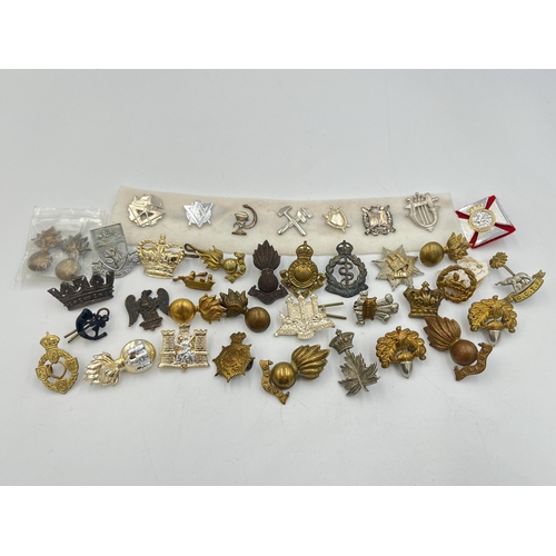 2168 - A collection of military collar badges