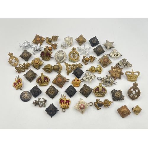 2169 - A collection of military collar badges