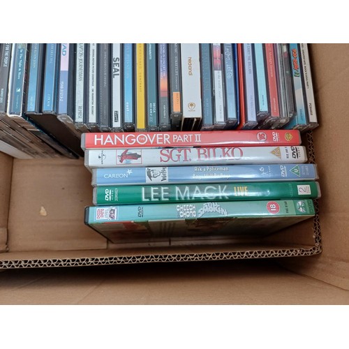 727 - Four boxes containing mixed media; CDs to include R.E.M., Genesis, Eric Clapton, Seal, Bryan Ferry &... 