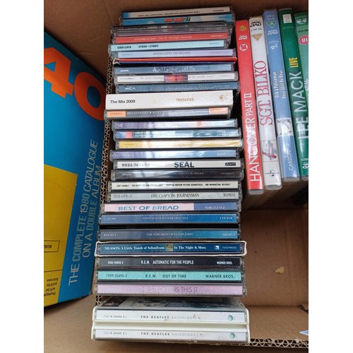 727 - Four boxes containing mixed media; CDs to include R.E.M., Genesis, Eric Clapton, Seal, Bryan Ferry &... 