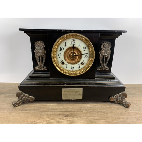 574 - An early 20th century black painted slate effect chiming mantel clock with Art Nouveau copper panell... 