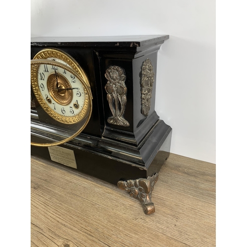 574 - An early 20th century black painted slate effect chiming mantel clock with Art Nouveau copper panell... 