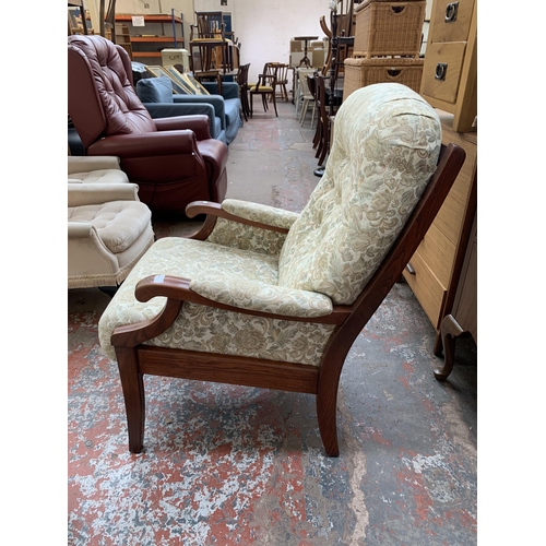 48 - A late 20th century elm and floral fabric upholstered armchair