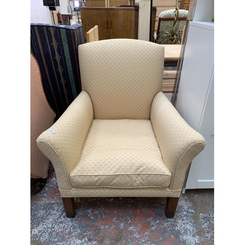 49 - A mid 20th century fabric upholstered armchair