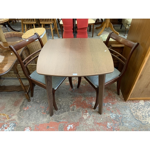 123 - Three pieces of furniture, one walnut effect dining table and two mahogany dining chairs