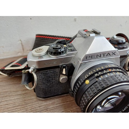 713 - Four 35mm SLR cameras, one Pentax ME Super fitted with Pentax-M 1:1.7 50mm lens, one Ricoh XR-X fitt... 