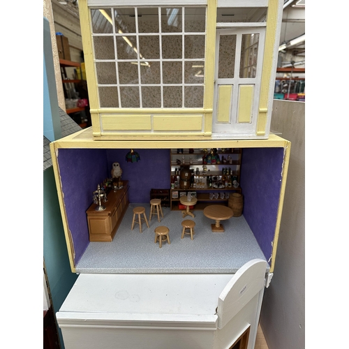 534 - A quantity of handmade and painted wooden doll's houses and accessories to include miniature bar, su... 