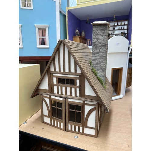 534 - A quantity of handmade and painted wooden doll's houses and accessories to include miniature bar, su... 