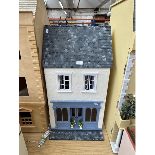 543 - A handmade and painted two storey shop front doll's house - approx. 79cm high x 42cm wide x 32cm dee... 