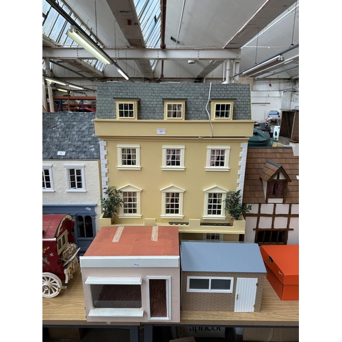 545 - Three handmade and painted wooden doll's houses - largest approx. 89cm high x 68cm wide x 41cm deep