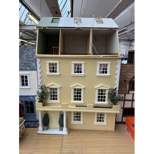 545 - Three handmade and painted wooden doll's houses - largest approx. 89cm high x 68cm wide x 41cm deep