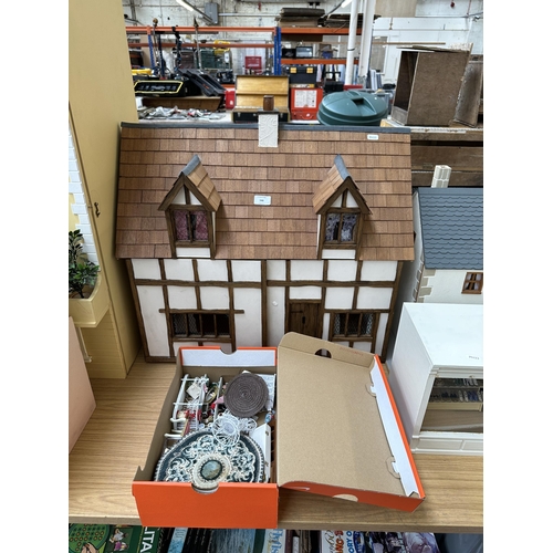 546 - A handmade and painted Tudor style two storey doll's house and accessories - approx. 63cm high x 67c... 