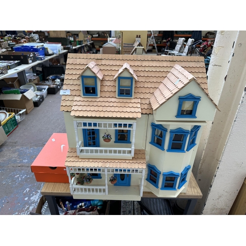 549 - A handmade and painted three storey doll's house and accessories - approx. 61cm high x 57cm wide x 3... 