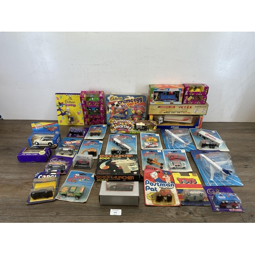 478 - A collection of boxed diecast model vehicles to include Smarties advertising van, Brooke Bond Bump &... 