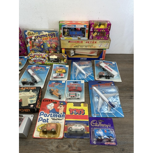 478 - A collection of boxed diecast model vehicles to include Smarties advertising van, Brooke Bond Bump &... 