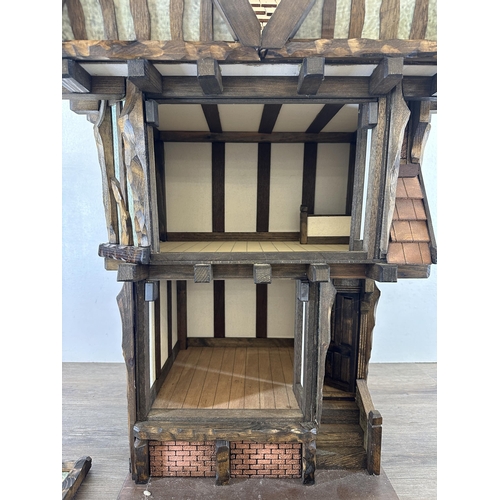 538 - A 2013 Roy Williams handmade Tudor style two storey doll's house - approx. 76cm high x 53cm wide x 3... 