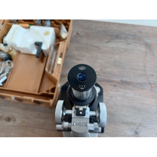 712 - A cased vintage Olympus student microscope with accessories to include Watson Para x100 2mm 1.30 O.I... 