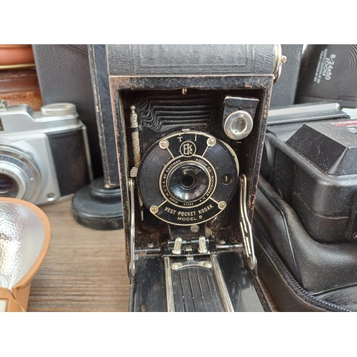 715 - A collection of vintage cameras, binoculars and accessories to include Kodak Baby Brownie, Prinz 10x... 