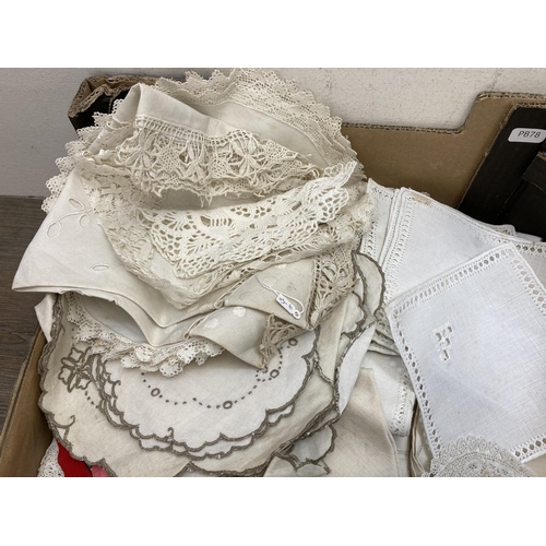 560 - Two boxes containing a collection of vintage embroidered and lace linen